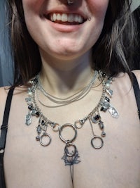 a woman with piercings and a necklace