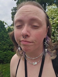 a woman with a nose piercing and ear piercings