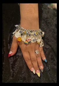 a woman's hand with a colorful bracelet on it