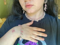 a woman wearing a pink necklace and bracelet